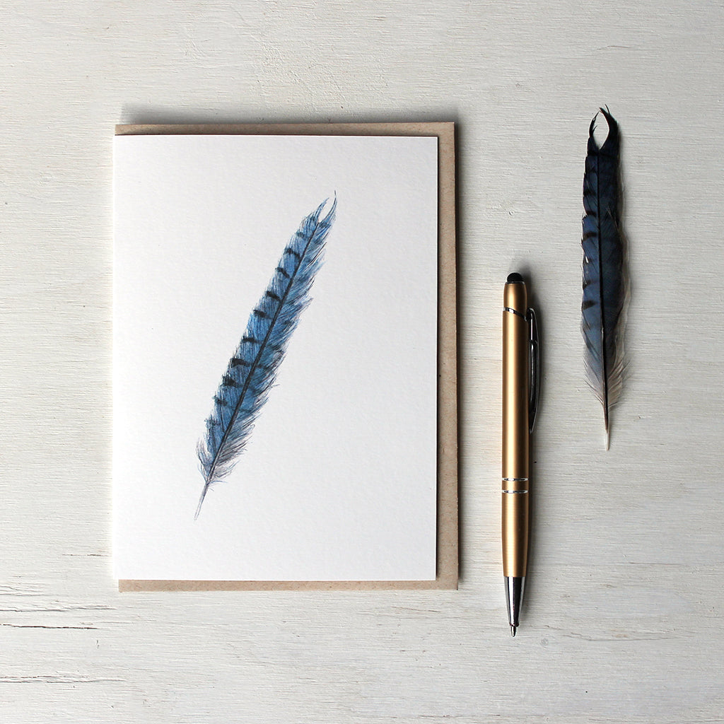 Note card featuring a blue jay feather watercolor painting. Artist Kathleen Maunder.