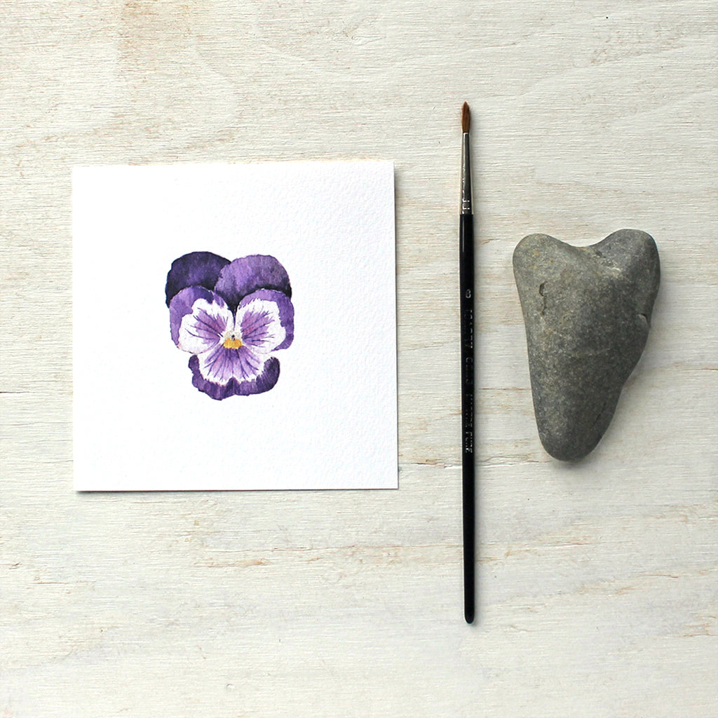 A watercolor art print of a dark purple pansy. Artist Kathleen Maunder.