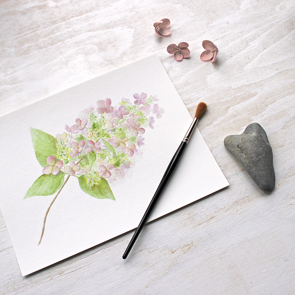 A lovely art print featuring a watercolour painting of a small branch of delicate pink hydrangea. Artist Kathleen Maunder.
