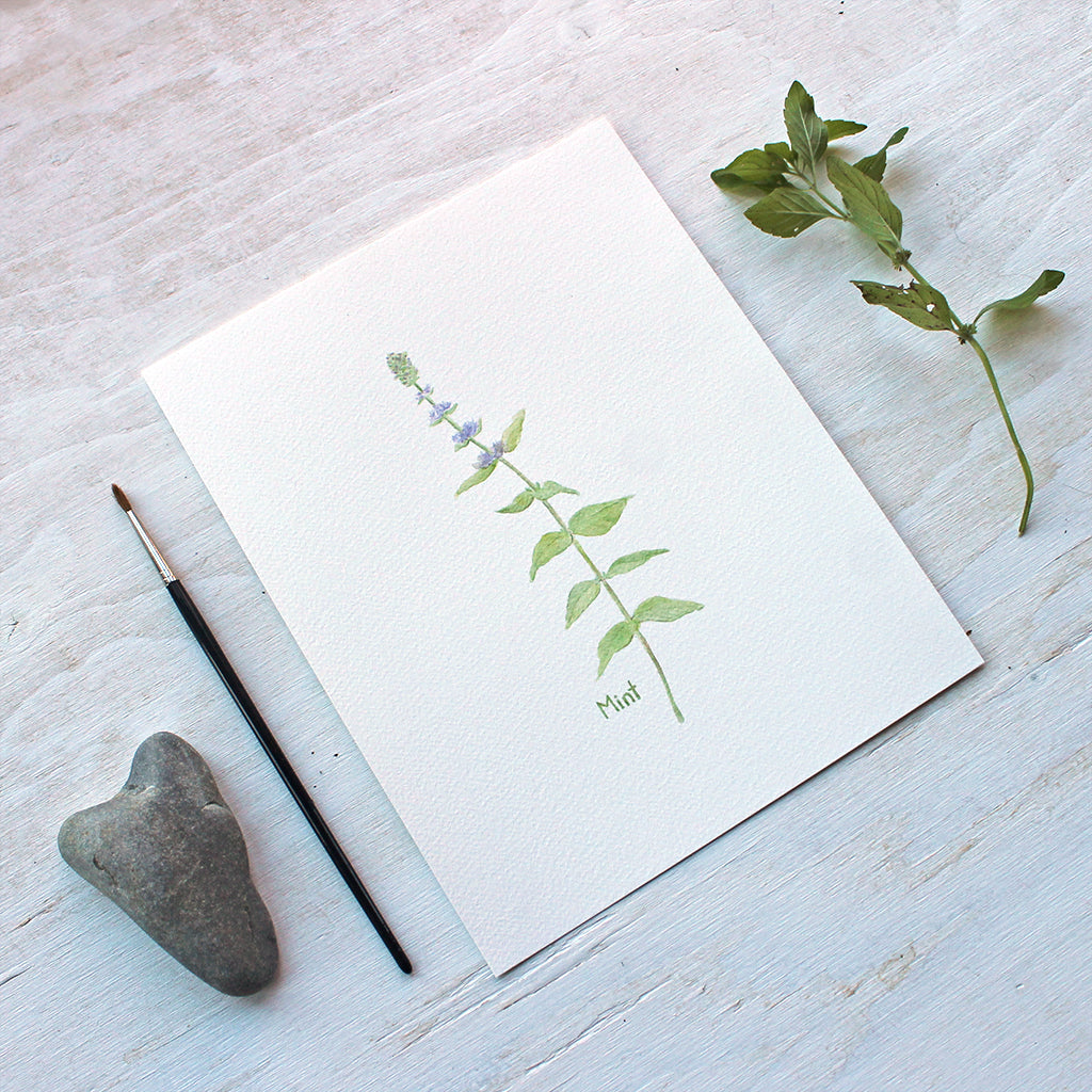 A botanical art print of a delicate watercolor painting of a stem of mint. Artist Kathleen Maunder.