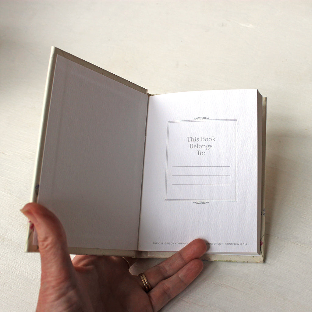 First page of hardcover notebook with perforated ruled pages. The floral watercolor paintings on the cover are by Kathleen Maunder.