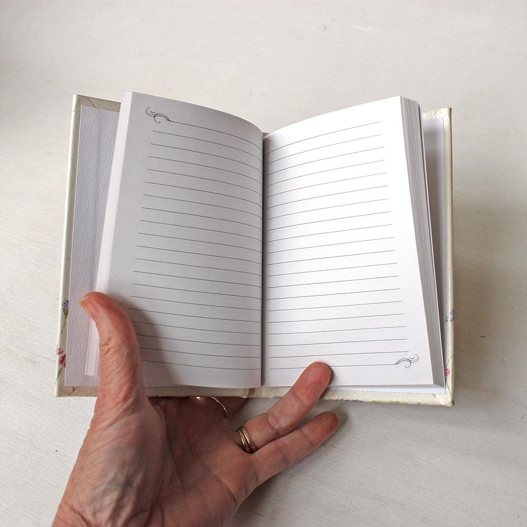 Inside pages of vintage hardcover notebooks. The floral watercolor paintings on the cover are by Kathleen Maunder.