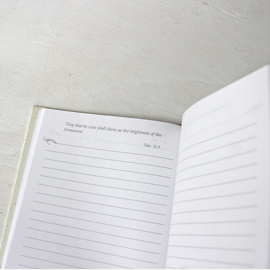 Inside pages of hardcover journal with Bible quotes.