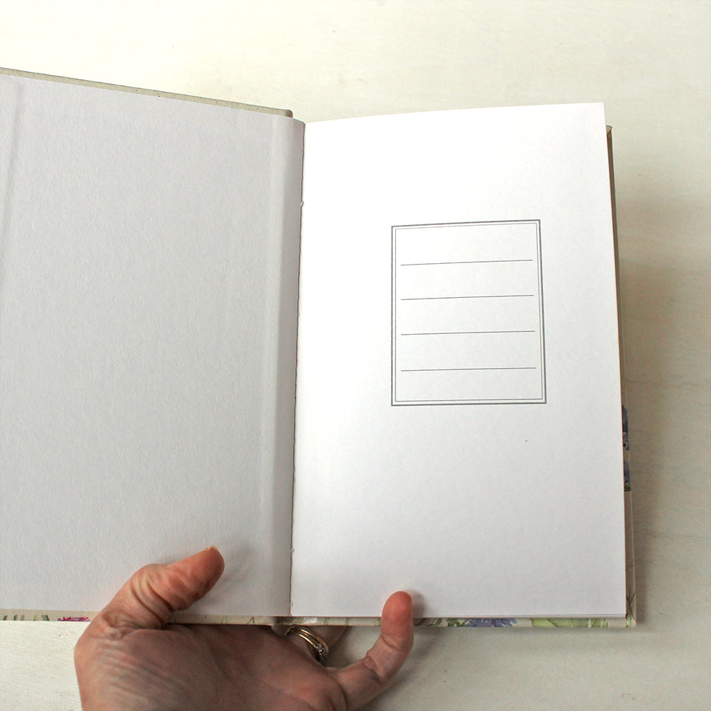 First page of hardcover journal with ruled pages. The floral watercolor paintings on the cover are by Kathleen Maunder.