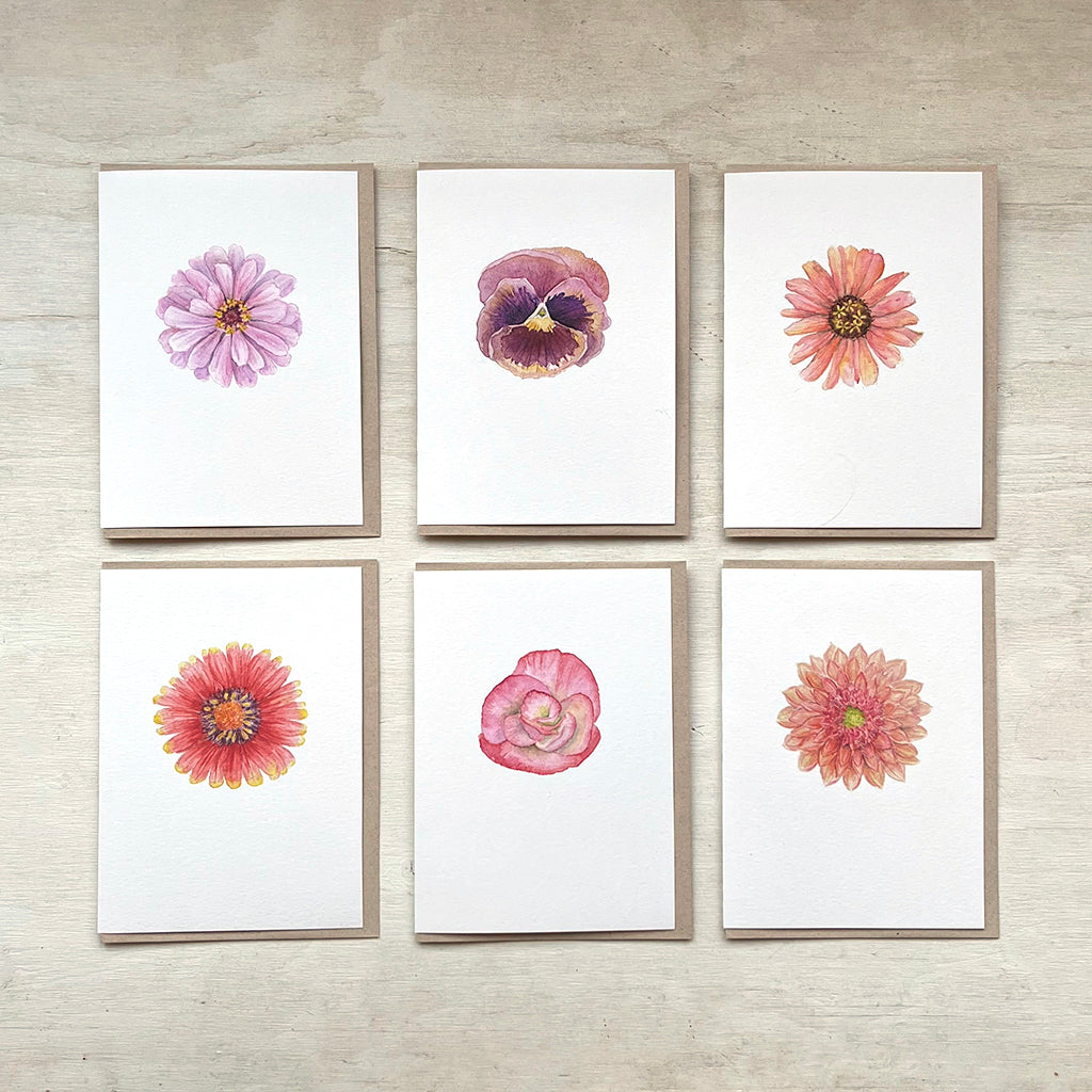 Set of six floral cards featuring close up botanical watercolour paintings by Canadian artist Kathleen Maunder. The images include a pink zinnia, pansy, peach zinnia, gaillardia, begonia and dahlia.