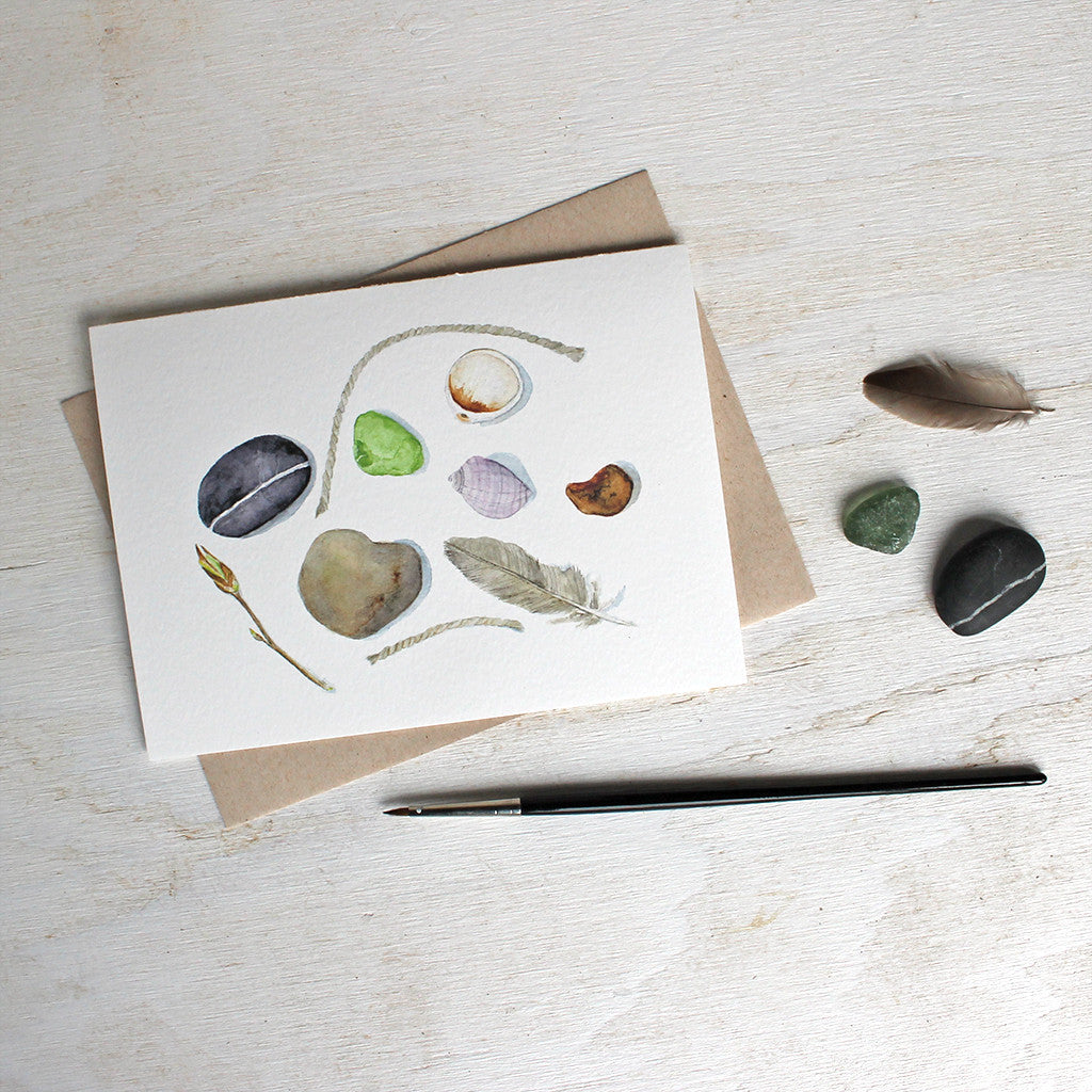 Note cards featuring a feather, shells, stones and sea glass painted in watercolor by Kathleen Maunder