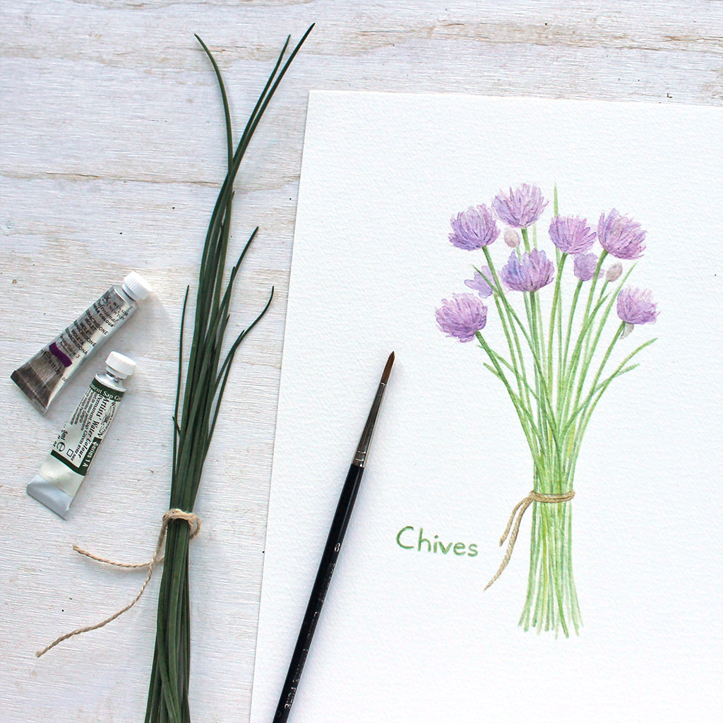 Close up of a reproduction of a watercolor painting of a bunch of purple chives tied with string by Kathleen Maunder, Trowel and Paintbrush