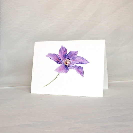 Note card featuring watercolor painting of a purple clematis flower. Artist Kathleen Maunder.