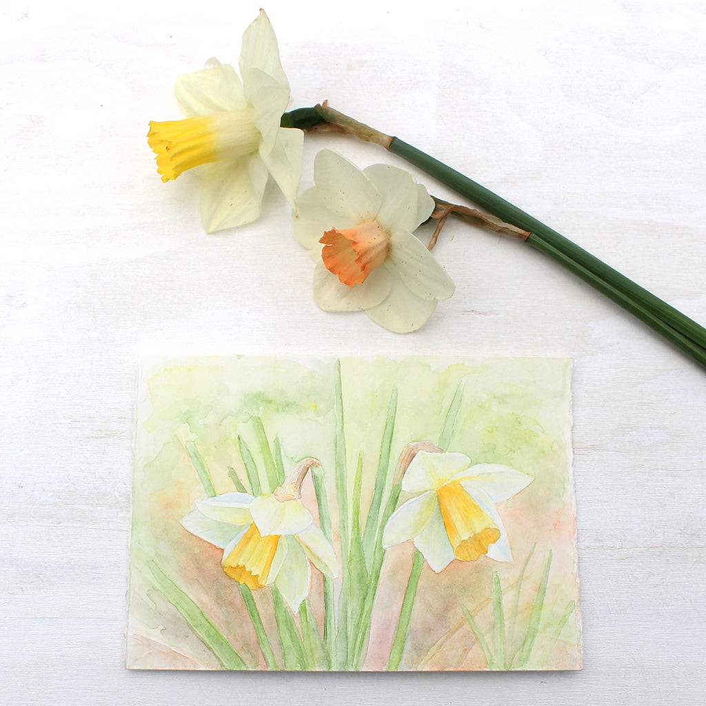 An original watercolour painting of two yellow daffodils. Artist Kathleen Maunder.