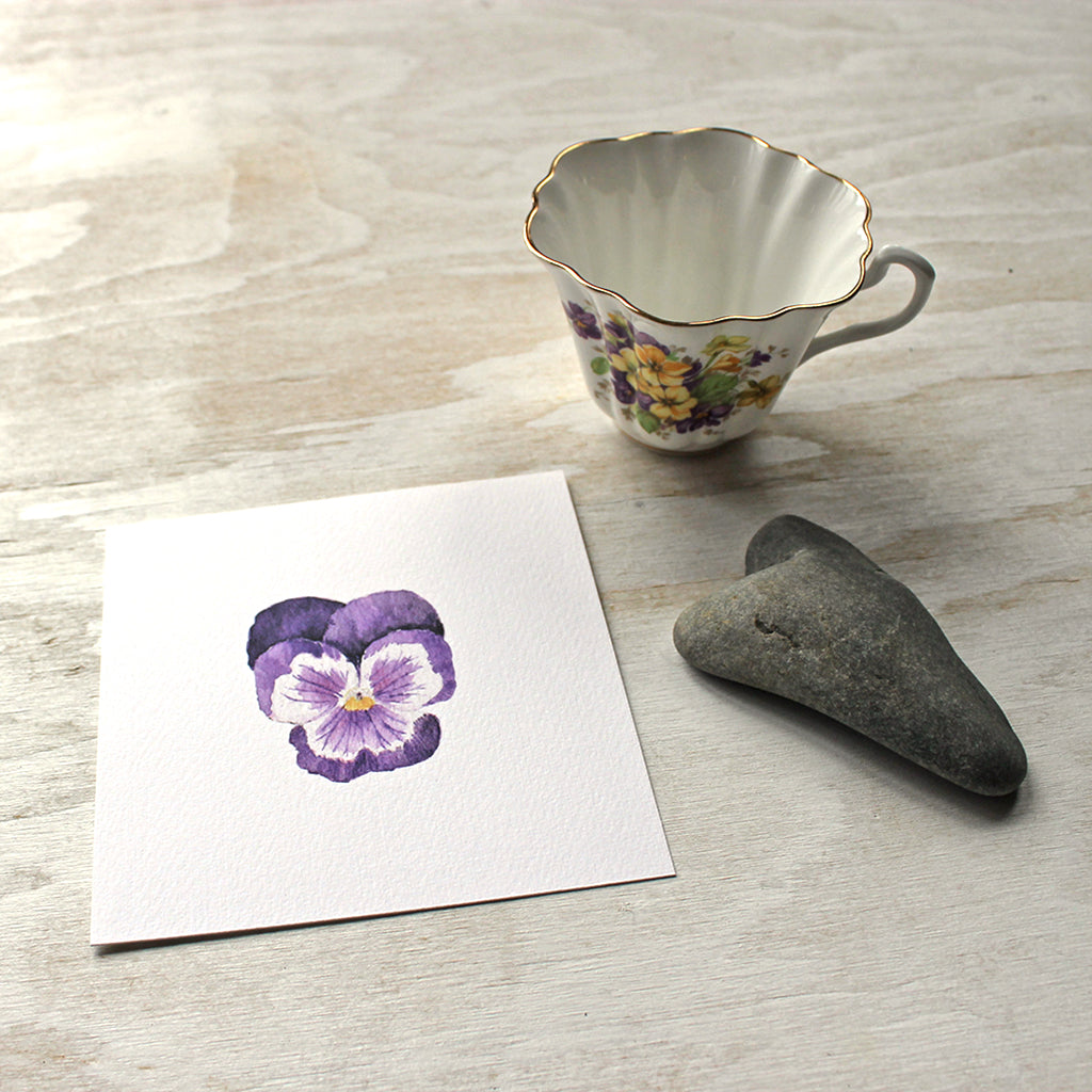 A lovely art print of a watercolor painting of a single dark purple pansy flower by artist Kathleen Maunder, trowelandpaintbrush