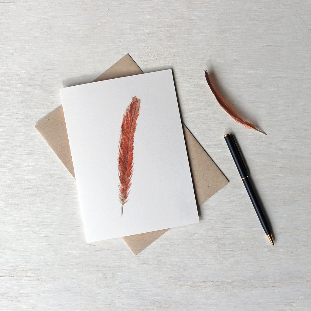 Note card featuring a watercolor painting of a female Northern cardinal's tail feather. Artist Kathleen Maunder.