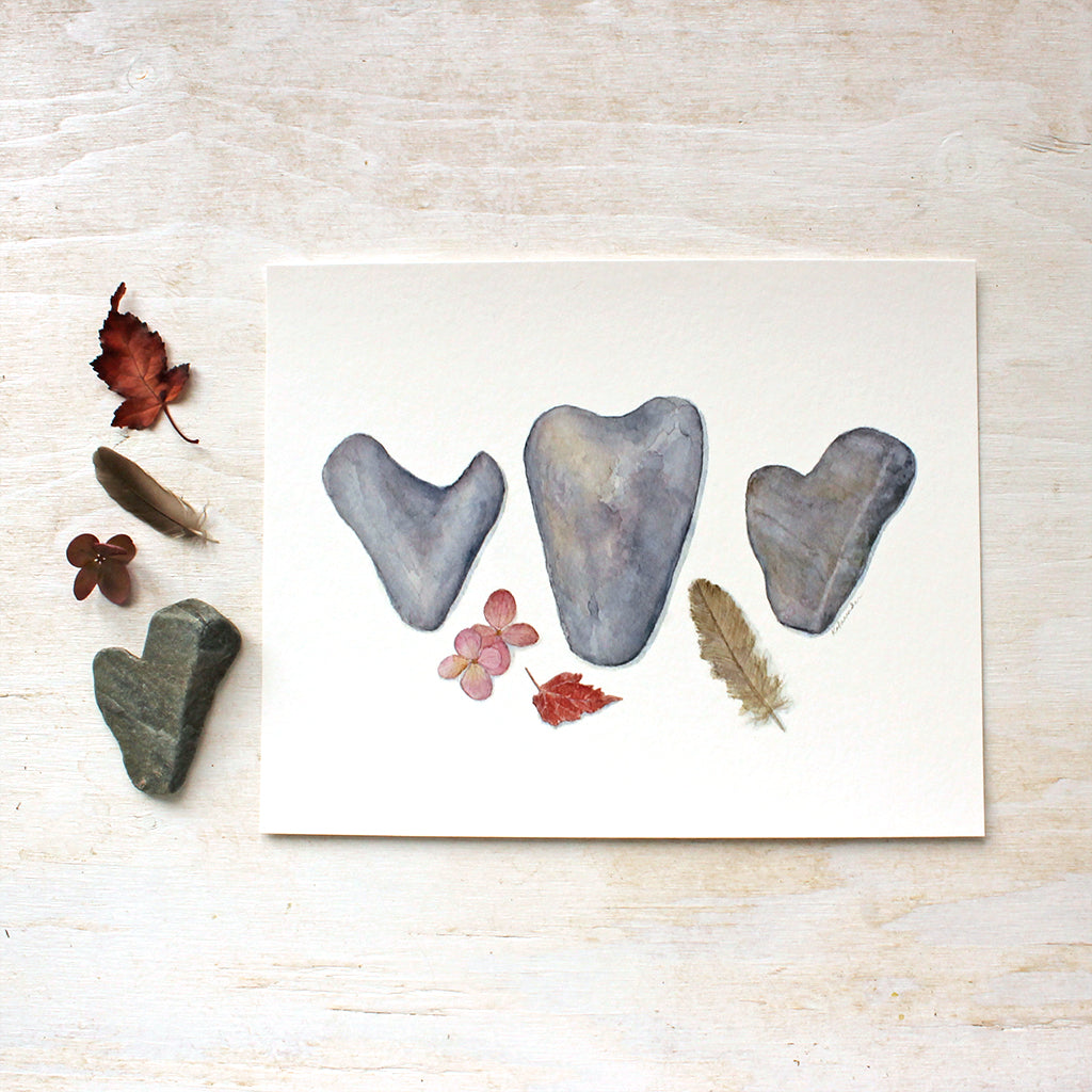 A trio of heart rocks / Hydrangea blossoms, a small autumn leaf and a sparrow feather / Watercolour painting by Kathleen Maunder / Available as an art print at Trowel and Paintbrush