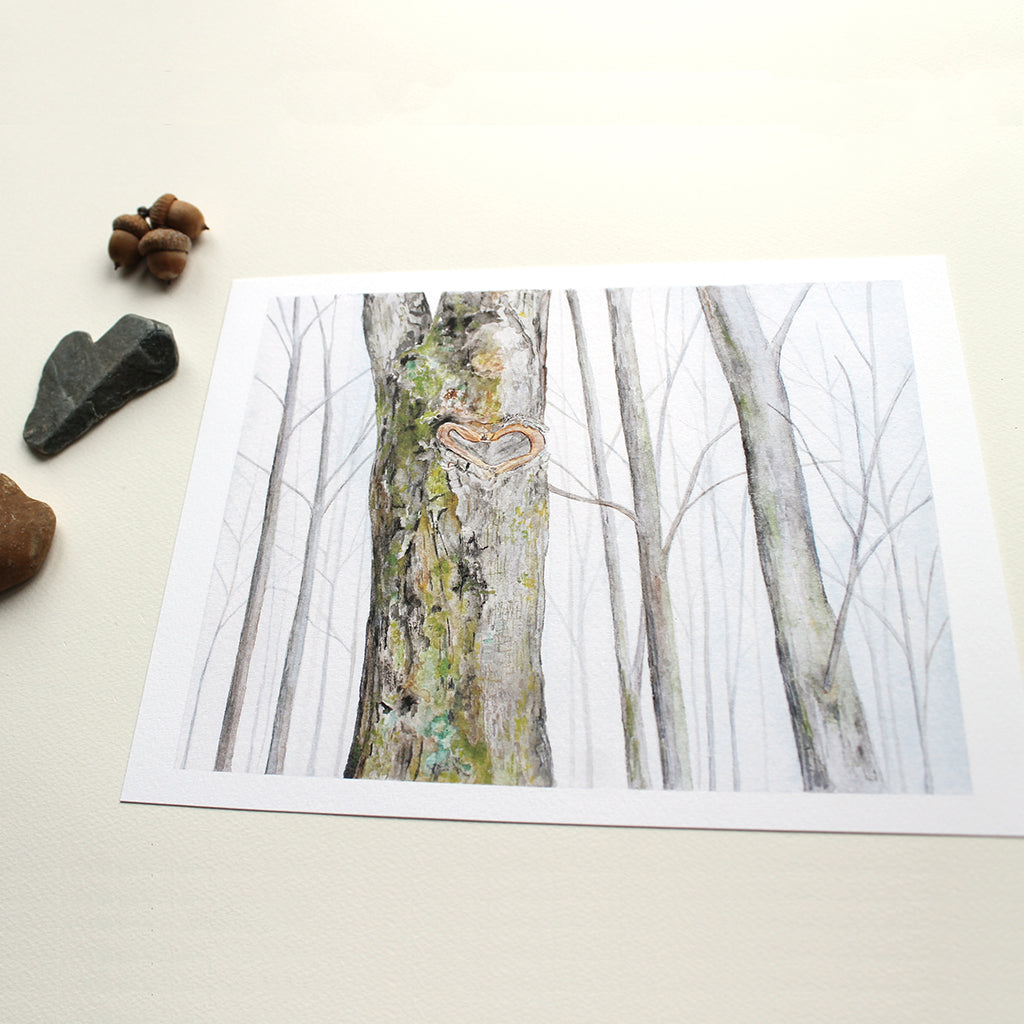 Art print of watercolor of a winter forest with a heart shaped formation on the moss and lichen covered trunk of one tree. Artist Kathleen Maunder