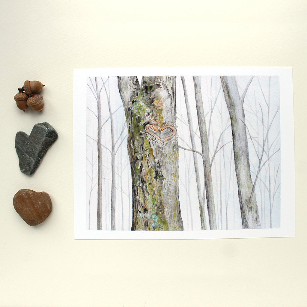 Art print of watercolor of a winter forest with a heart shaped formation on the trunk of one tree. Lovely detail of green and yellow lichen on the bark of the tree. Artist Kathleen Maunder