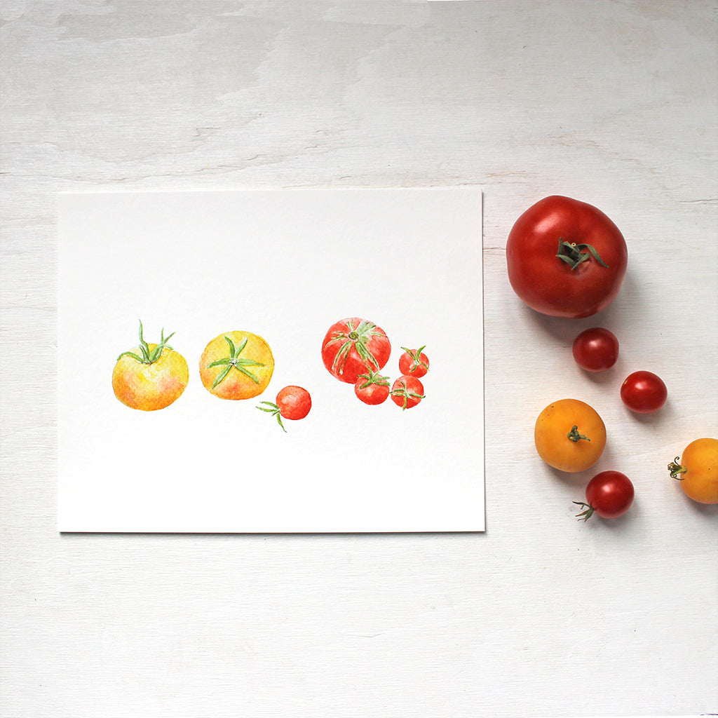 A watercolor art print depicting a grouping of small yellow and red heirloom tomatoes. Artist Kathleen Maunder.