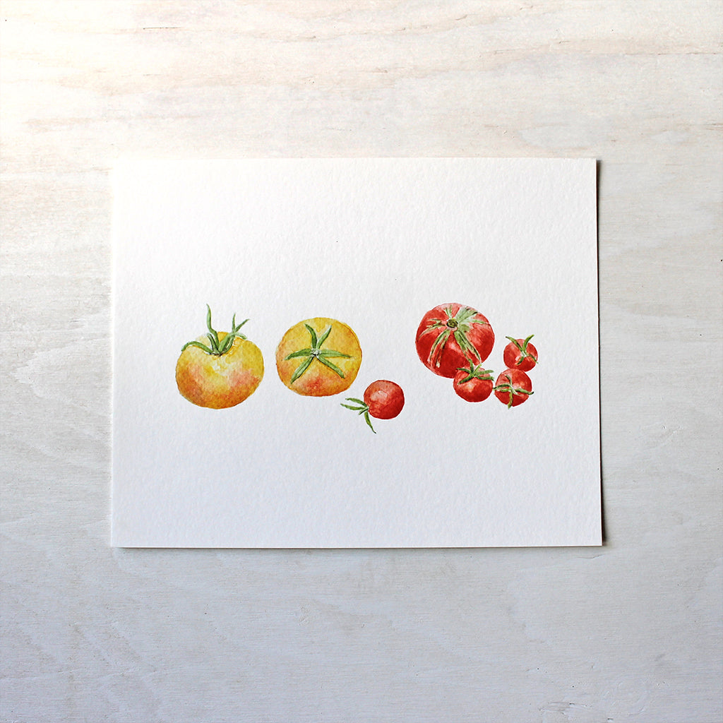 A watercolor art print of seven small yellow and red heirloom tomatoes. Artist Kathleen Maunder.