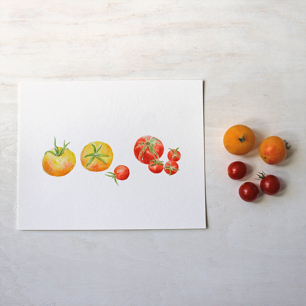 An art print of seven small yellow and red heirloom tomatoes by watercolor artist Kathleen Maunder.