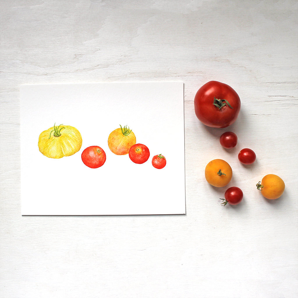 A watercolor art print depicting a grouping  of red and yellow heirloom tomatoes. Artist Kathleen Maunder.