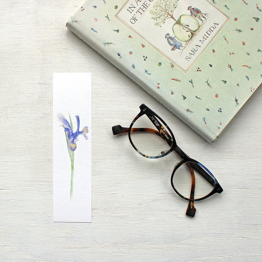 Paper bookmark featuring a watercolor painting of a Siberian iris. Artist Kathleen Maunder.