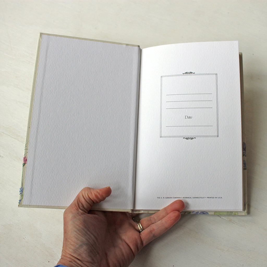 First page of vintage hardcover journal with ruled pages. The floral watercolor paintings on the cover are by Kathleen Maunder.