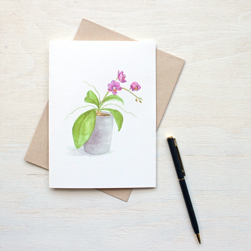 Note card featuring a watercolor painting of a pot of tiny magenta orchids by artist Kathleen Maunder.