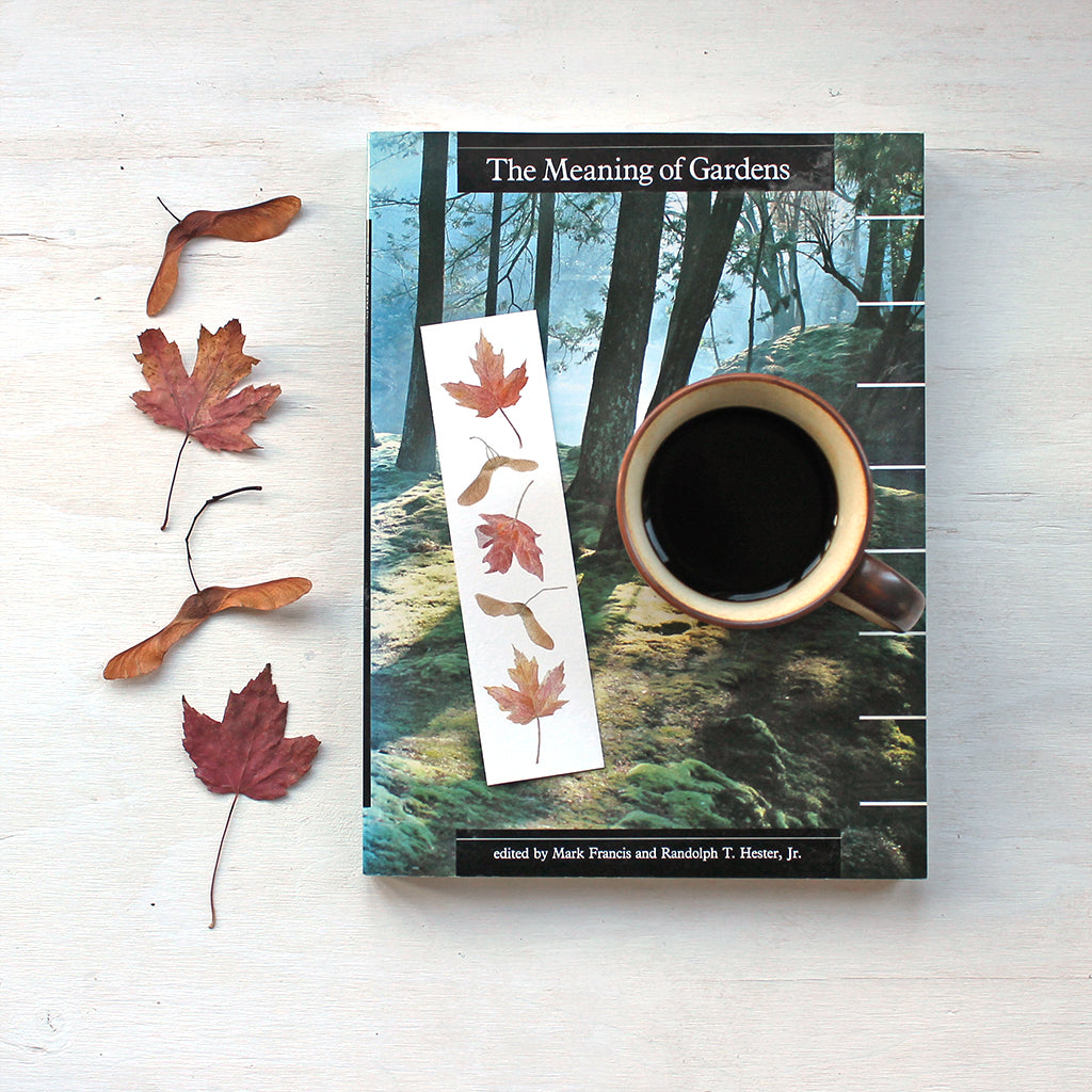 Bookmark featuring a watercolor painting of maples leaves and keys by artist Kathleen Maunder 