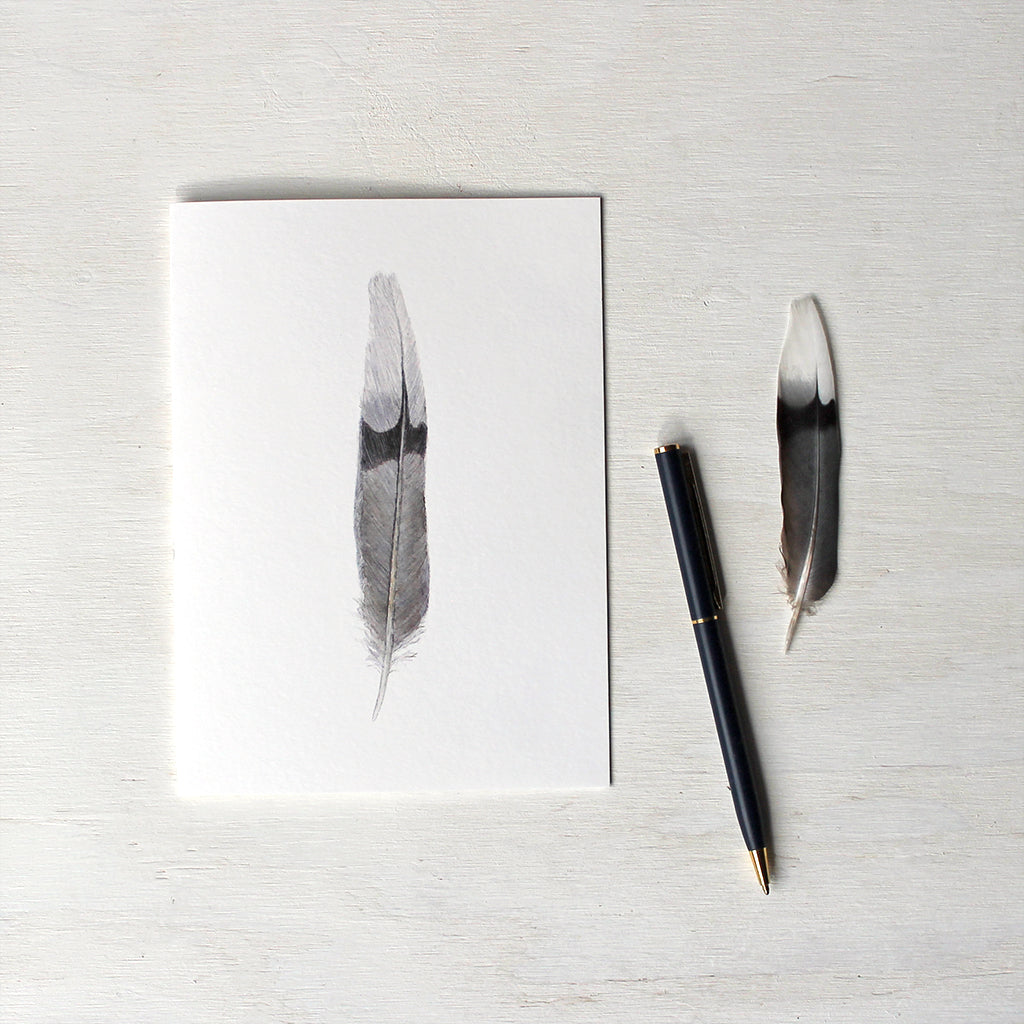 Note card featuring an original watercolor painting of a mourning dove feather. Artist Kathleen Maunder.