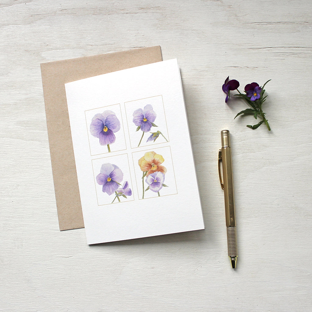 Four purple and gold pansy images painted in watercolor and featured on notecards. Artist Kathleen Maunder.