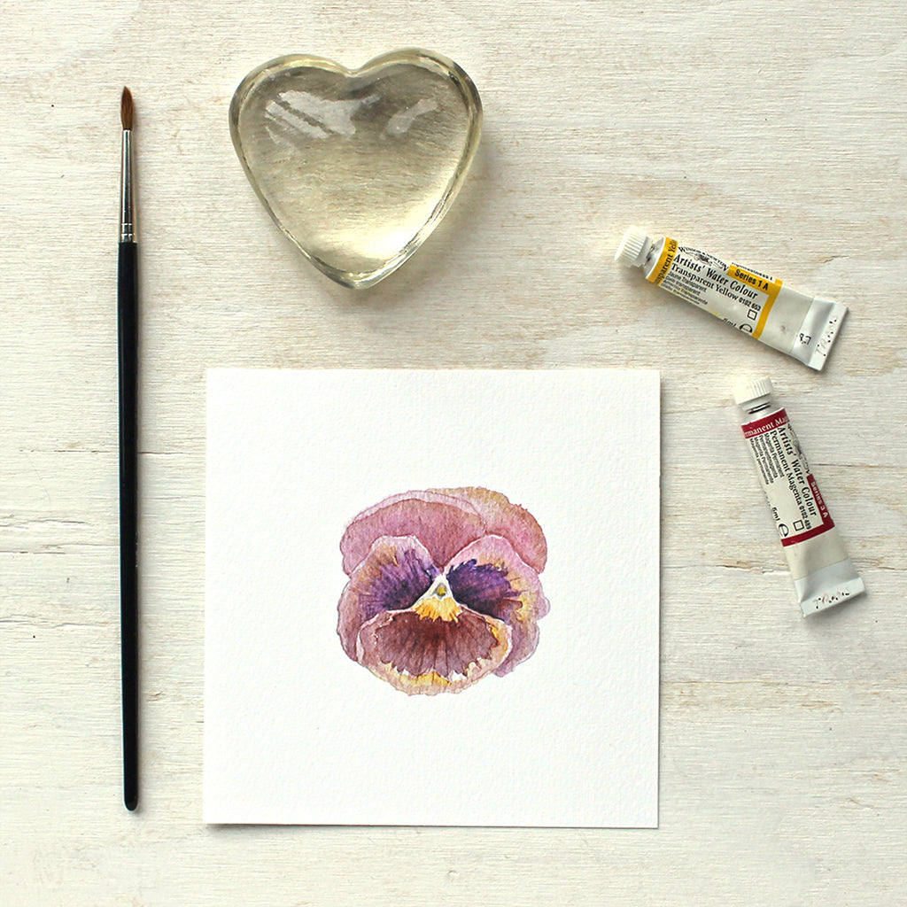 An art print of a lovely watercolor painting of a burgundy red and purple pansy by artist Kathleen Maunder.
