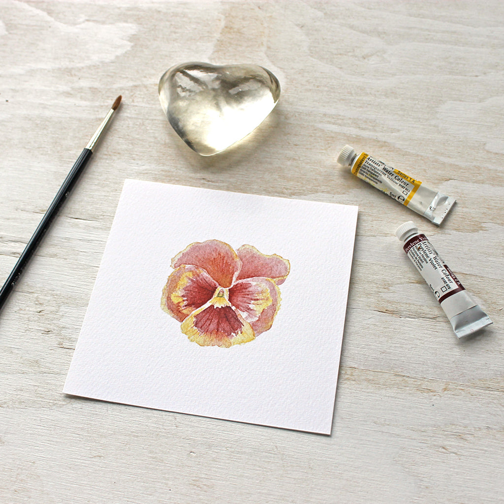 A lovely rusty red and yellow pansy painted in watercolor. Available as an art print. Artist Kathleen Maunder.