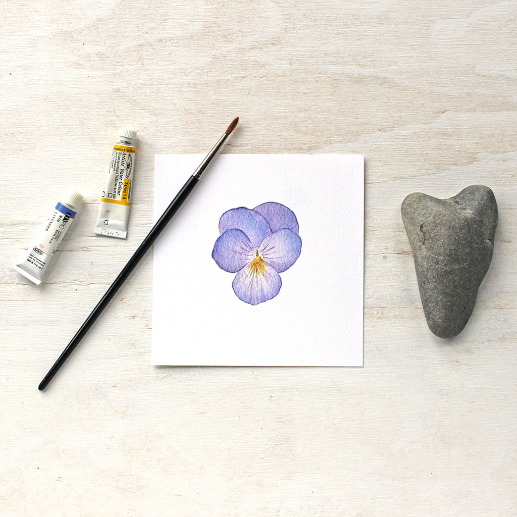 An art print of a watercolour painting of a lovely lavender pansy flower with a yellow center. Artist Kathleen Maunder.