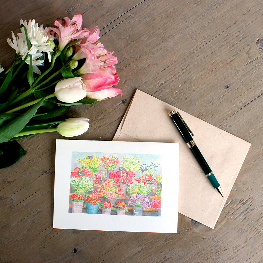 This lovely note card features a watercolor painting of the colourful flower market or 'marché aux fleurs' on Île de la Cité in Paris. Artist Kathleen Maunder.