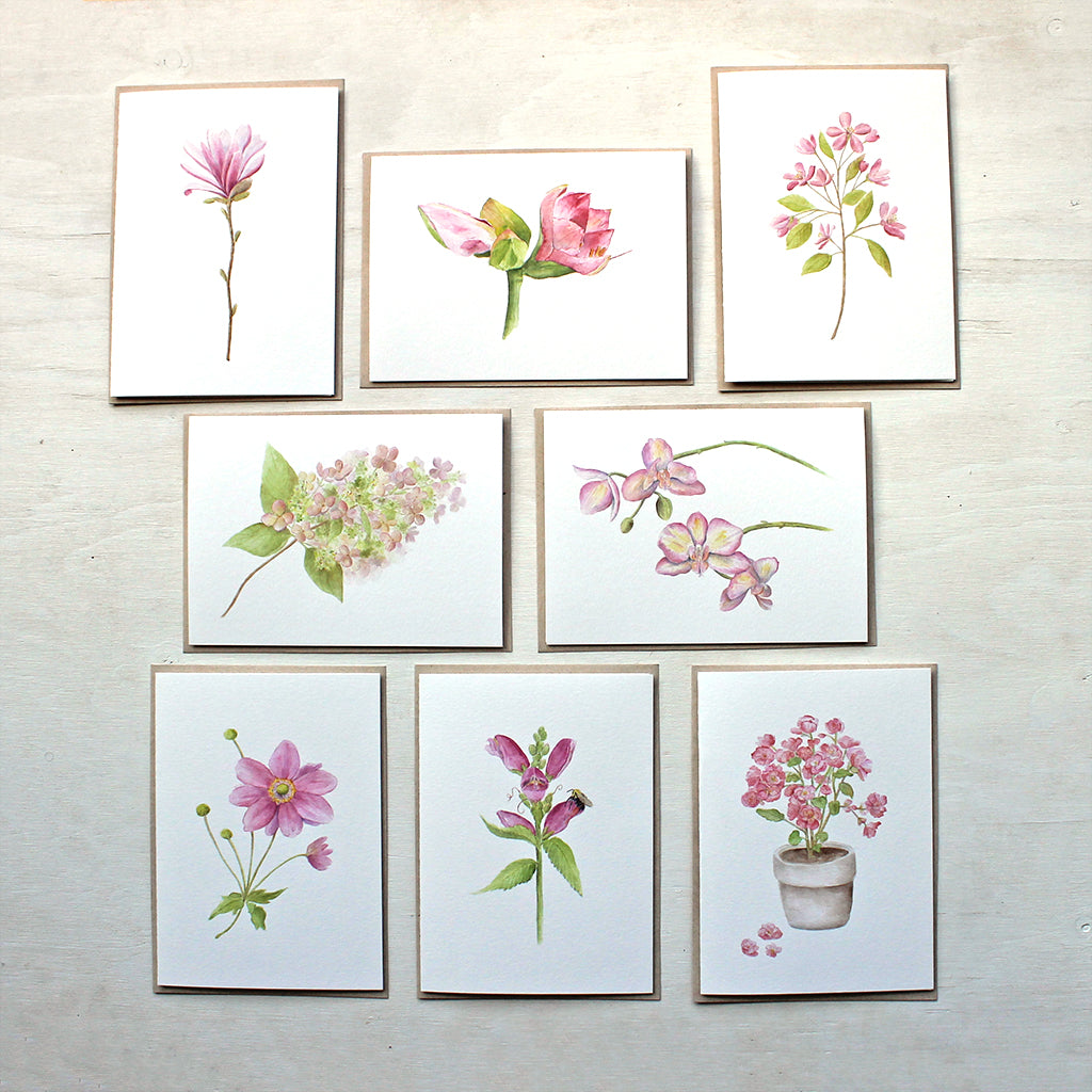 Set of eight pink floral note cards featuring: star magnolia, amaryllis, crabapple, hydrangea, orchid, Japanese anemone, turtlehead and pink begonia. Painted in watercolor by Kathleen Maunder.