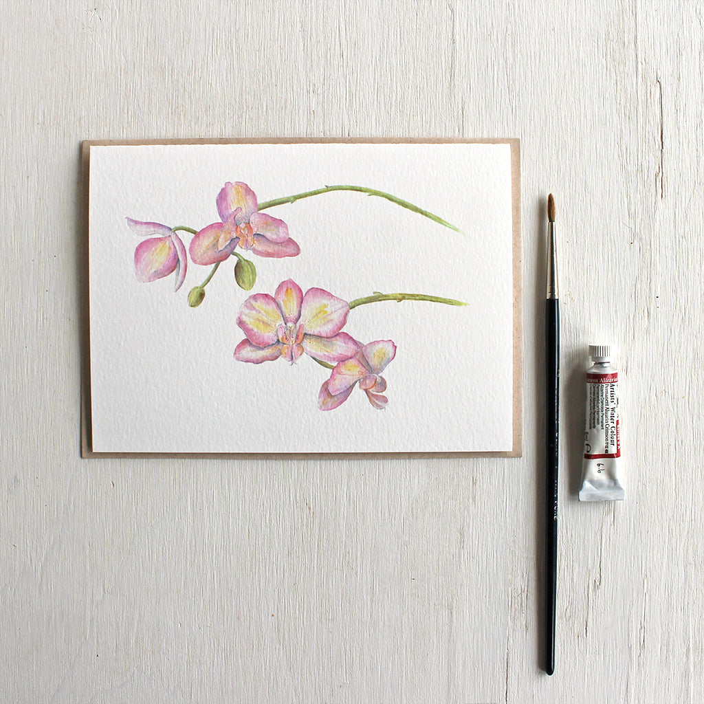 Note card featuring watercolor painting of pink and yellow orchids. Artist Kathleen Maunder.