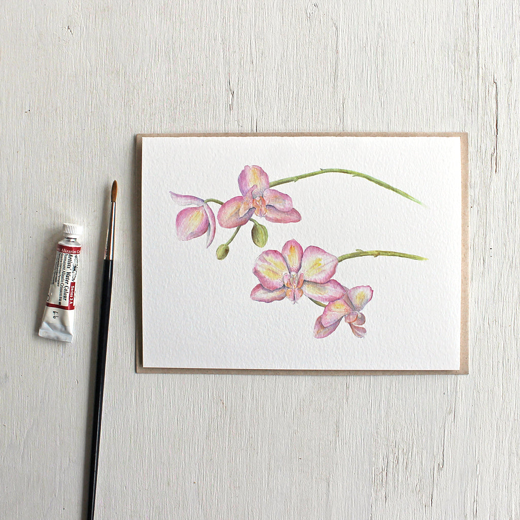 Note card with watercolour painting of pink and yellow orchids.