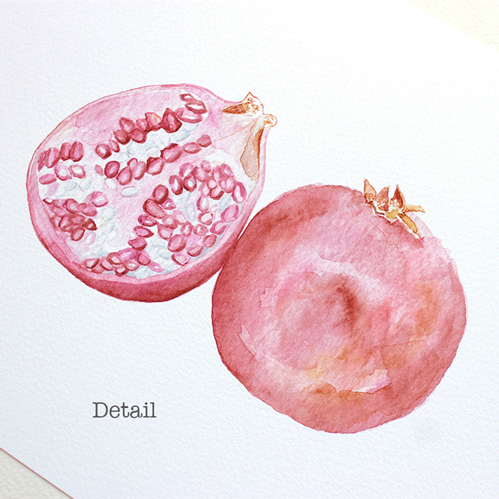 Detail of a watercolor art print of two beautiful pomegranates. Artist Kathleen Maunder.