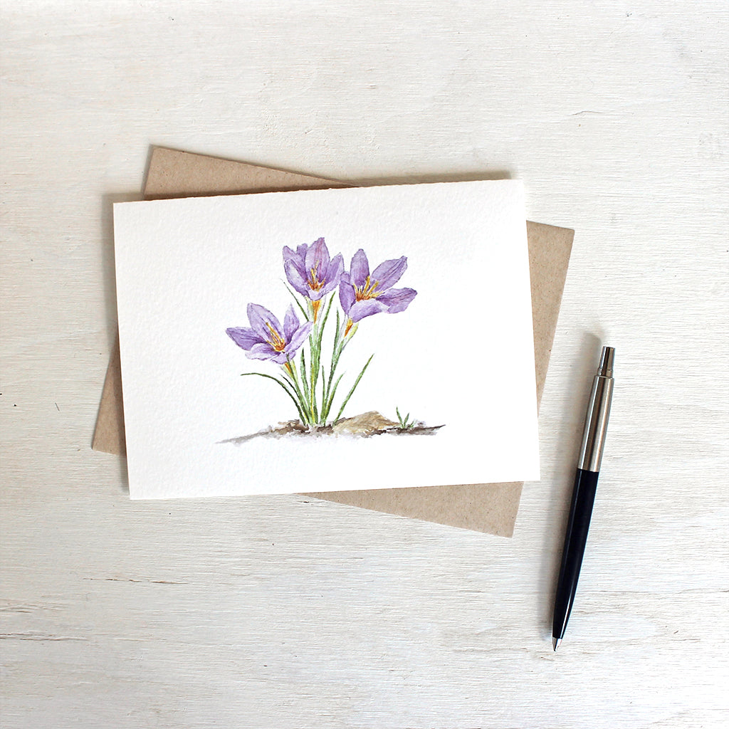Three purple crocuses featured on watercolor note card