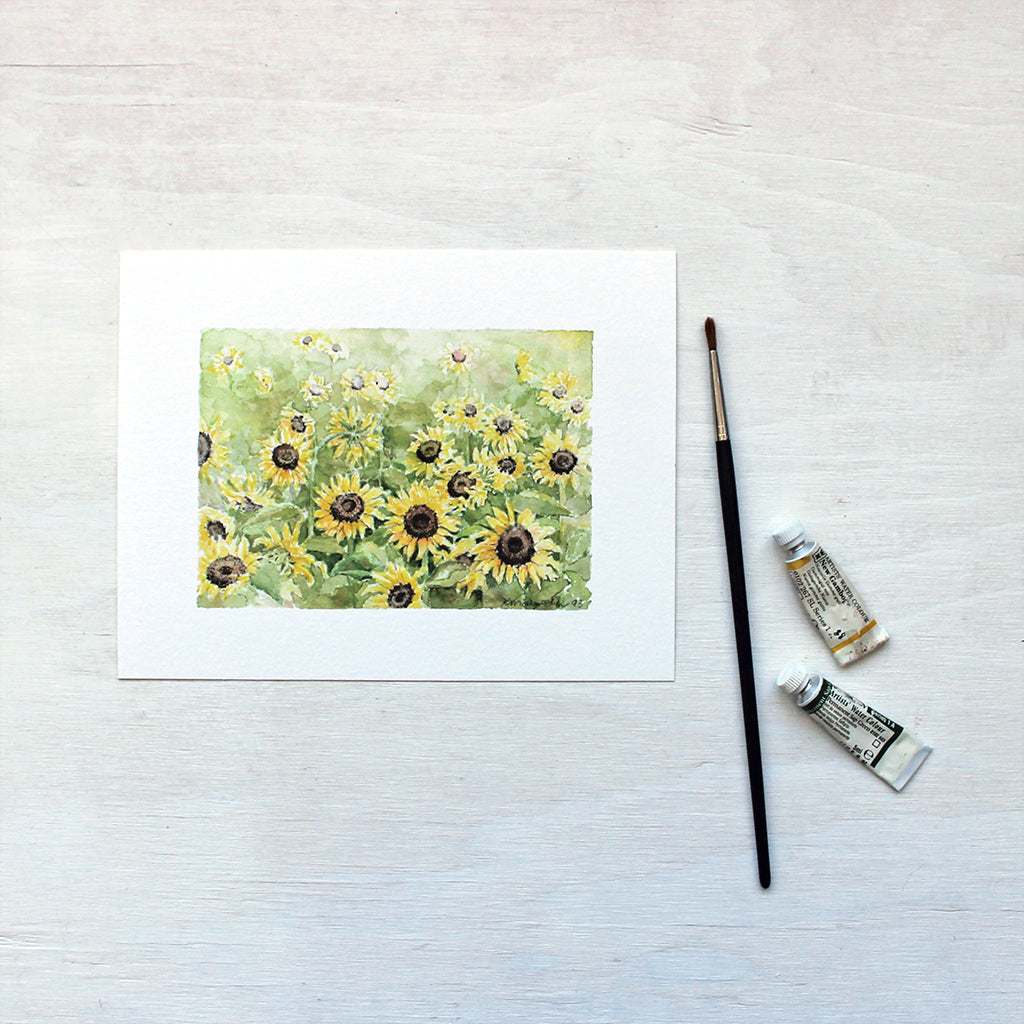 A lovely 8x6 inch art print featuring a watercolor painting of a sunflower field. Artist Kathleen Maunder.