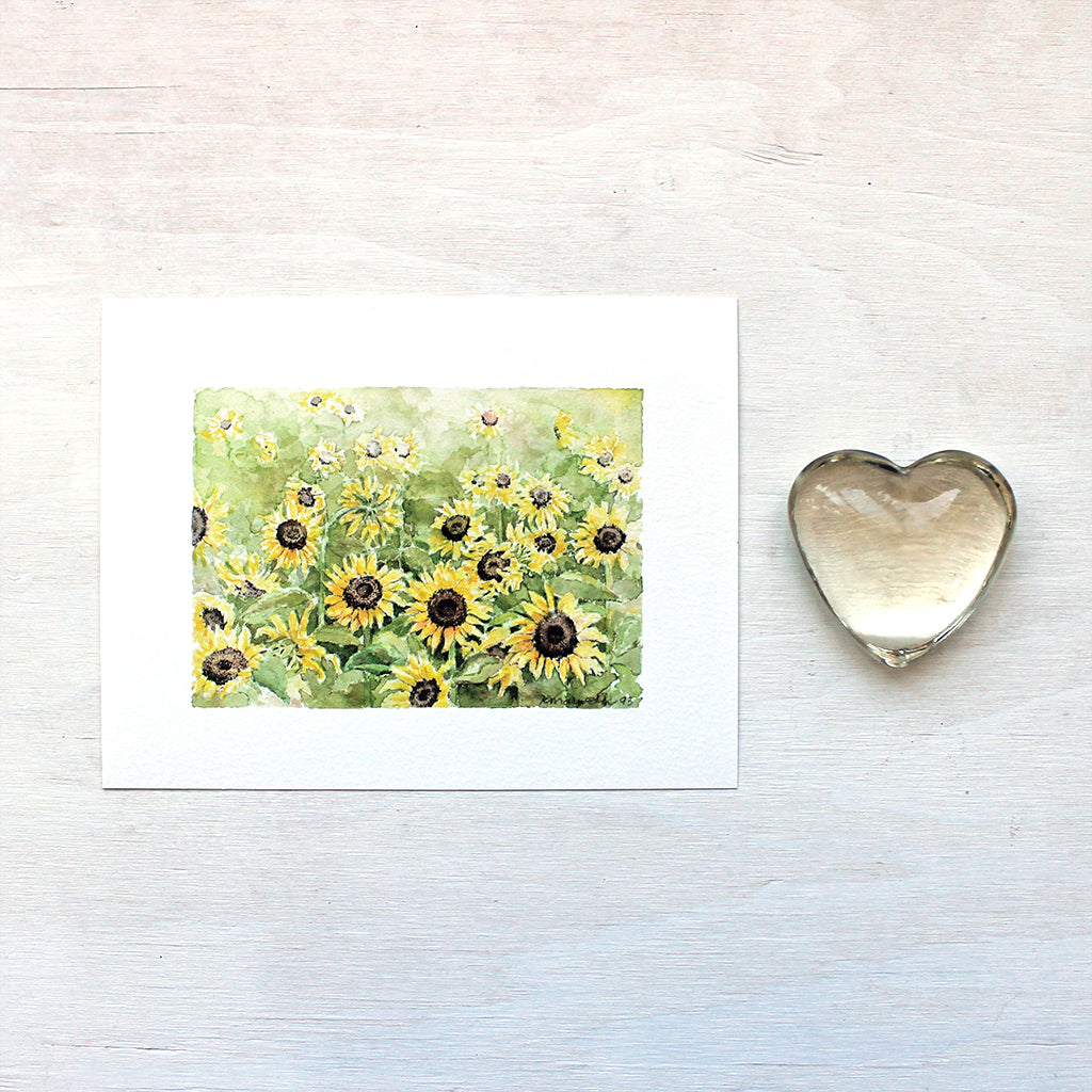 A beautiful art print featuring a watercolour painting of a sunflower field. Artist Kathleen Maunder.