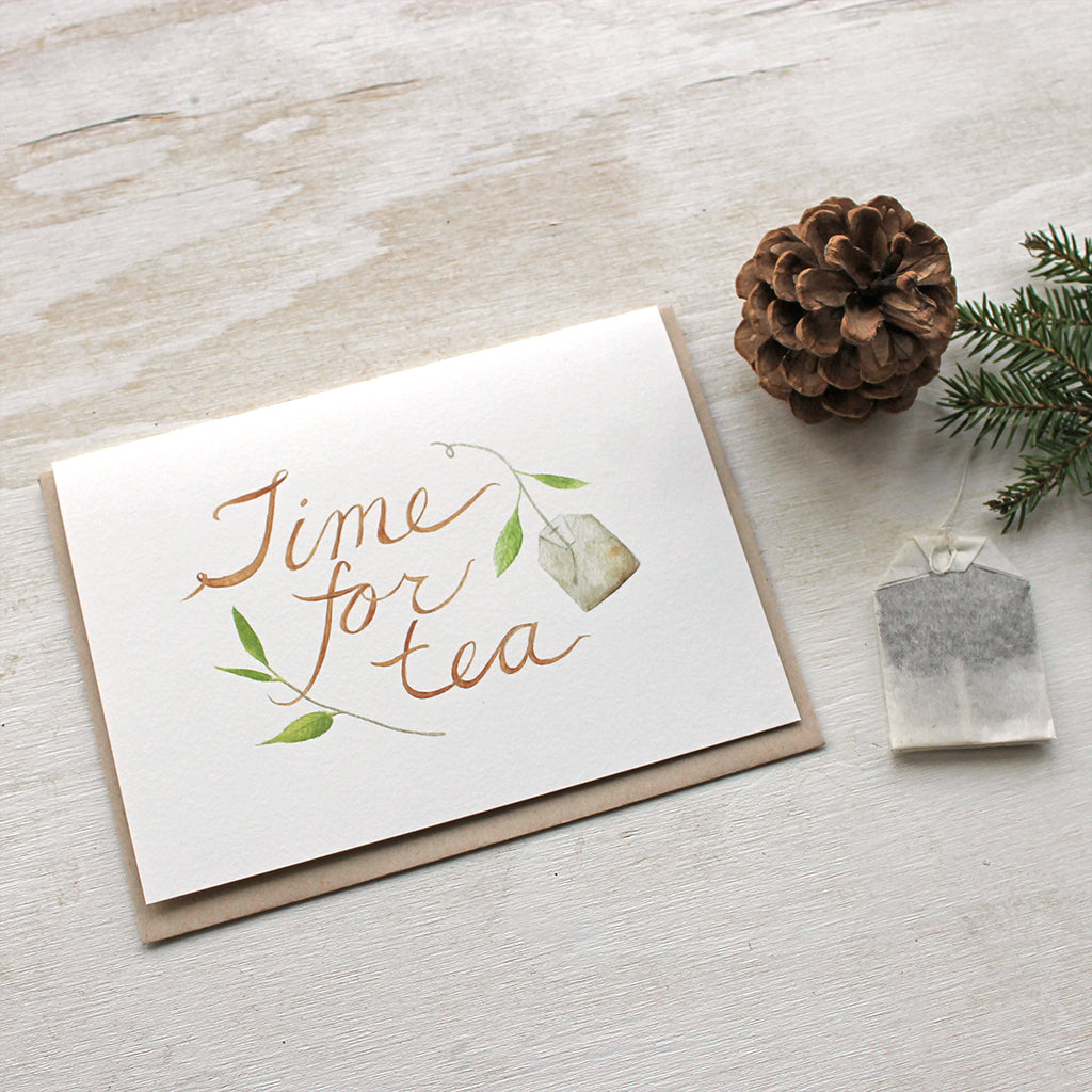 Tea note cards with a delicate watercolor painting of tea leaves, a tea bag and hand lettered 'Time for Tea' message. Artist Kathleen Maunder of Trowel and Paintbrush