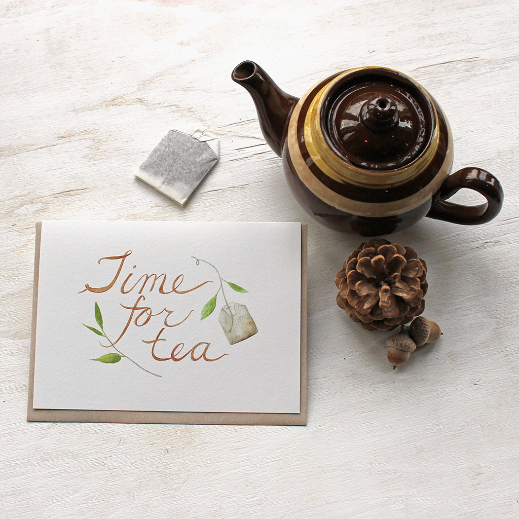 Tea note cards with a delicate watercolor painting of tea leaves, a tea bag and hand lettered 'Time for Tea' message. Artist Kathleen Maunder of Trowel and Paintbrush