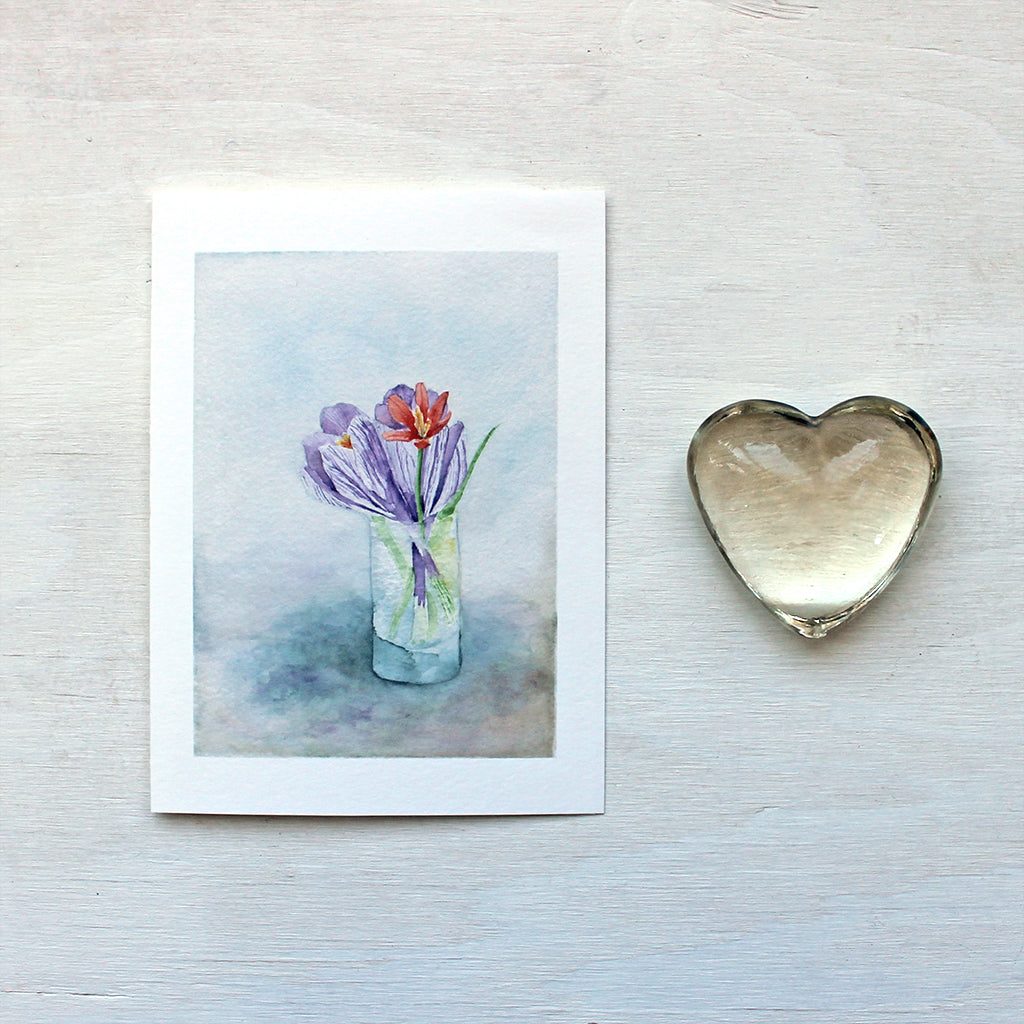 A beautiful note card featuring a watercolor painting of a tiny vase of spring flowers: two crocuses and a botanical tulip. Artist Kathleen Maunder.
