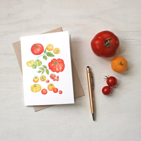 A note card depicting several kinds of red, yellow and green heirloom tomatoes by watercolor artist Kathleen Maunder.