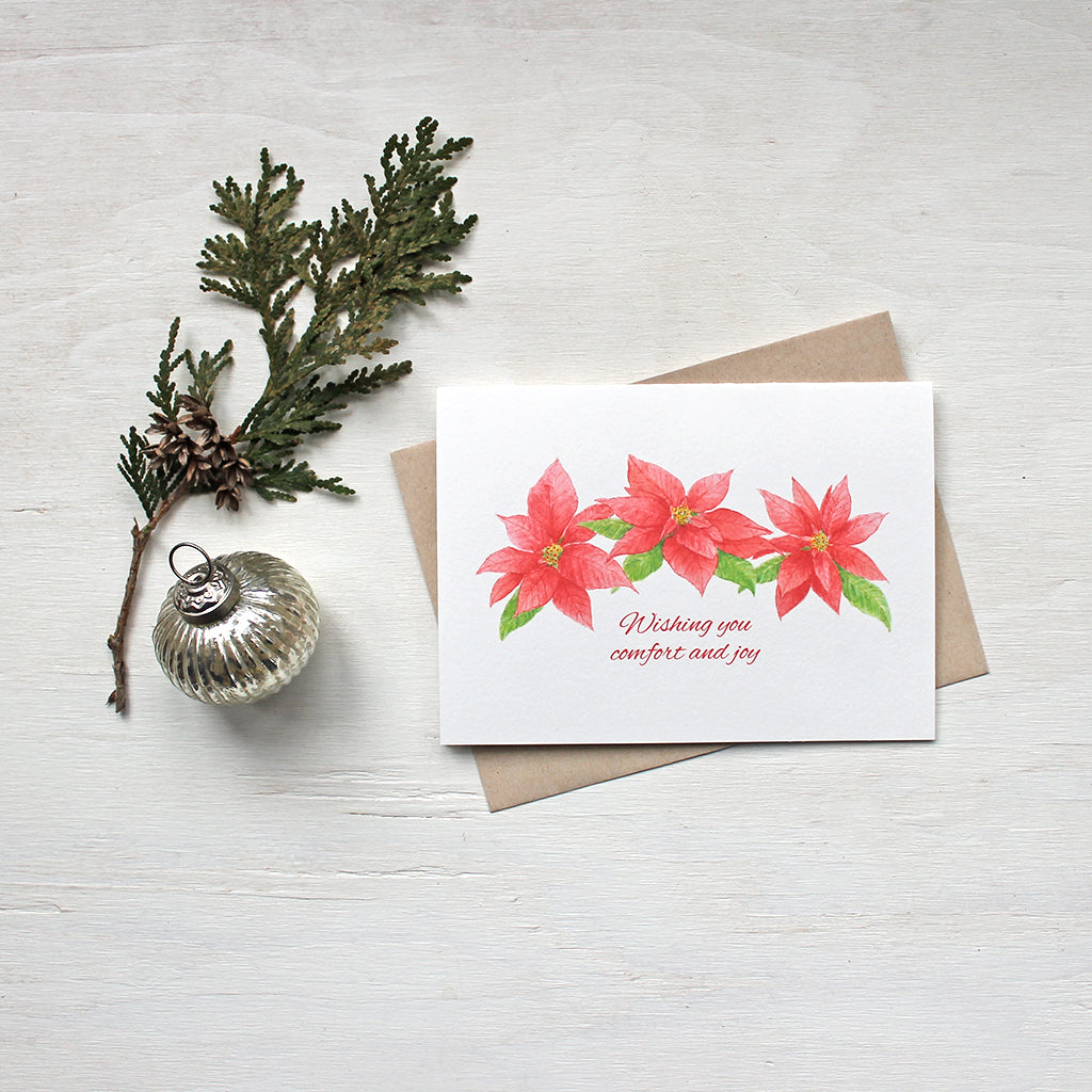 Holiday cards featuring three red poinsettias painted in watercolor by artist Kathleen Maunder
