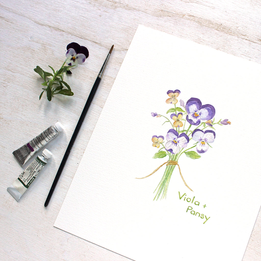 A botanical watercolor painting of a posy of pansies and violas. Available as art print. Artist Kathleen Maunder.