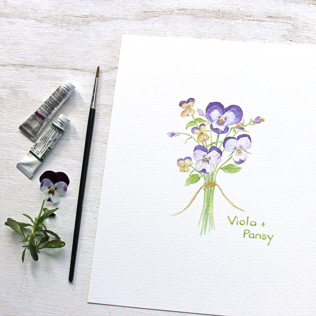 A botanical watercolor painting of a posy of edible pansies and violas. Available as art print. Artist Kathleen Maunder.
