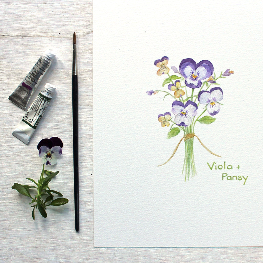 A delicate watercolor painting of a small bouquet of pansies and violas tied with string. Available as art print. Artist Kathleen Maunder.
