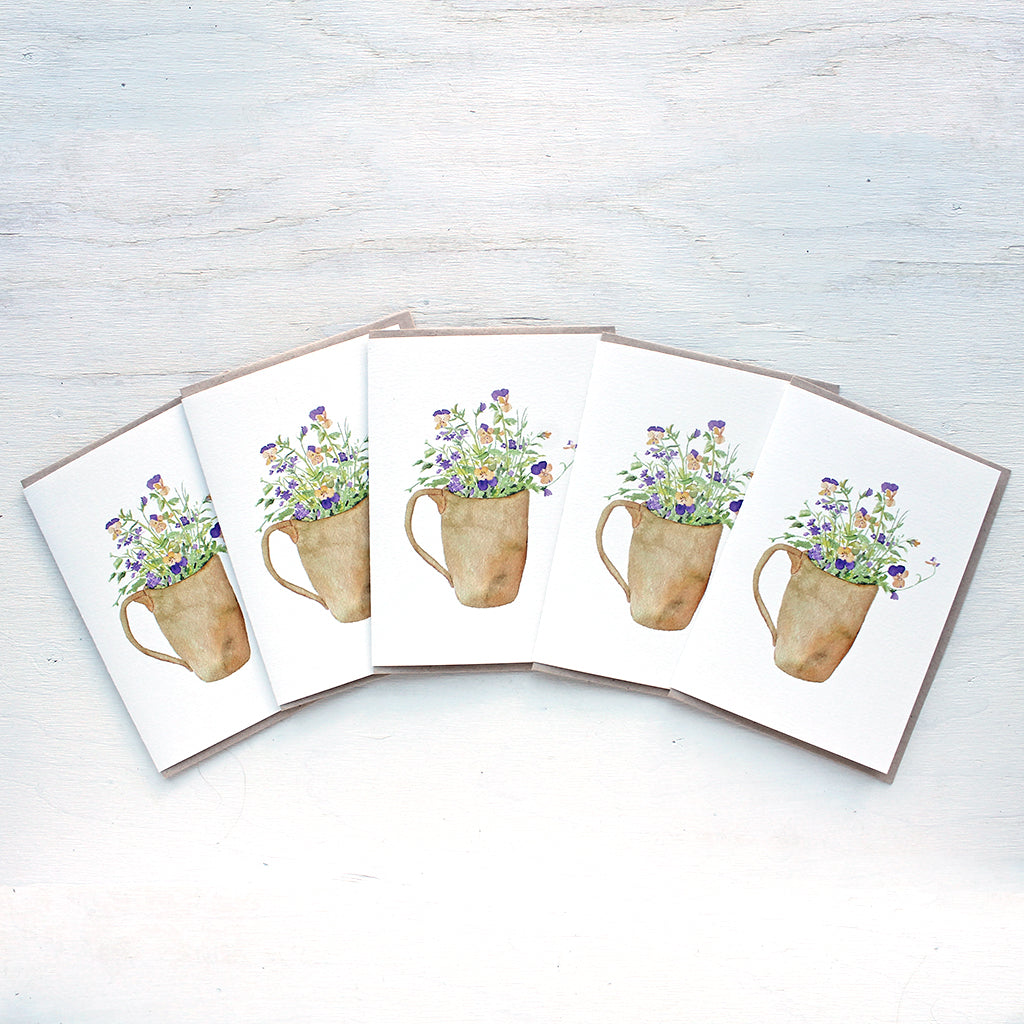 A set of five note cards featuring a watercolor painting of violas and verbena. Artist Kathleen Maunder