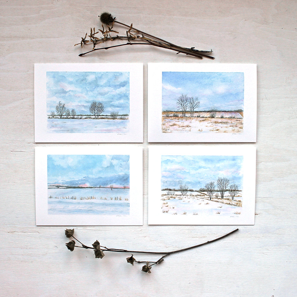 Note card assortment featuring four different winter landscape paintings by watercolour artist Kathleen Maunder. 