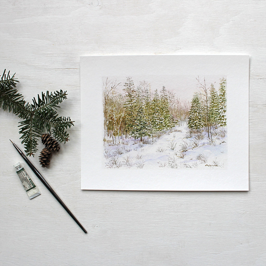 An art print featuring a delicate and detailed watercolour  of a winter forest painted by Kathleen Maunder